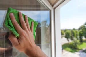 Residential window cleaning service in Canton MA removing dirt and streaks from glass